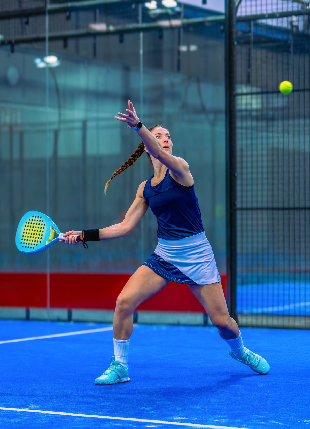 Player in position on indoor padel court